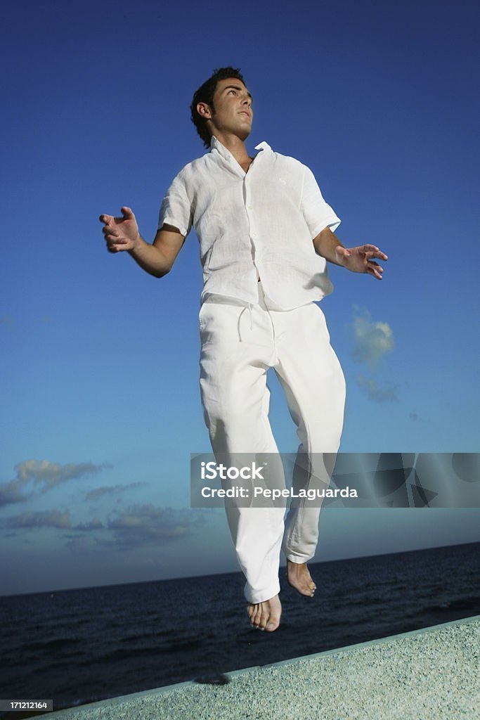 Summer vitality Young man jumping with freedom. 25-29 Years Stock Photo