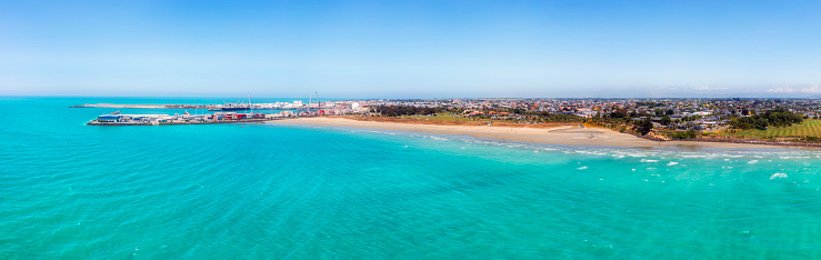 Coastal aerial panorama of Timaru port town in New Zealand on South Island - scenic Caroline beach on town waterfront.