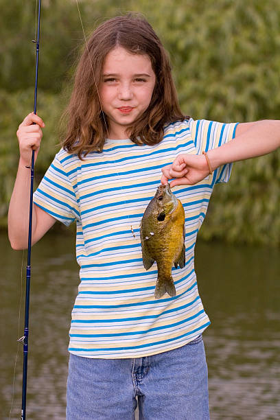 Young girl showing off the fish she just caught