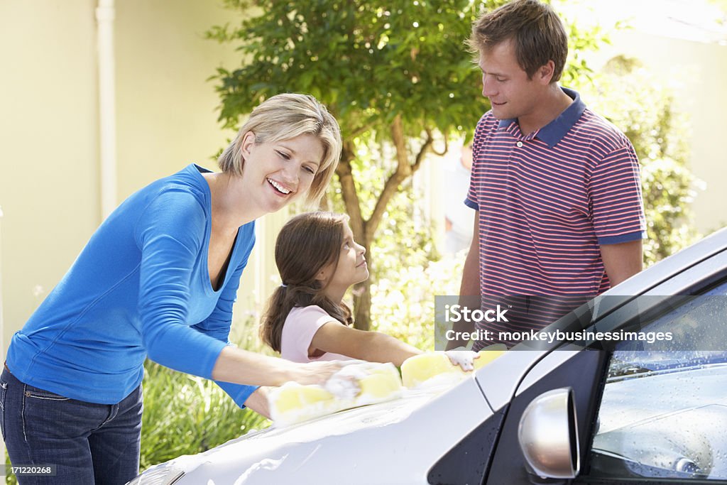 Family Washing Car Together Family Washing Car Together Smiling And Laughing. 30-39 Years Stock Photo