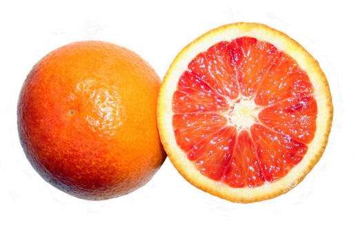 A pretty blood orange, halved, isolated on a white background. 