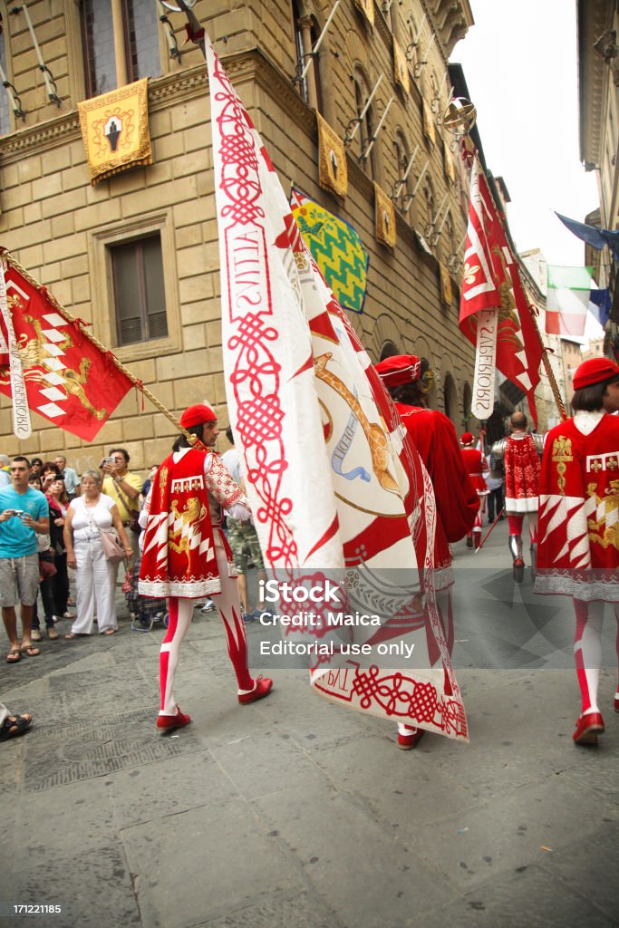 Siena contrades parade "Siena, Italy - July, 2,2011: View of the Cortejo Storico, or historical parade, as performed in the city of Siena in Tuscany, Italy. It is a medieval costume parade which takes place before famous Palio horse racing every July 2 and August 16. In the shot, members of one of Siena's contrades wearing their colors." Adult Stock Photo