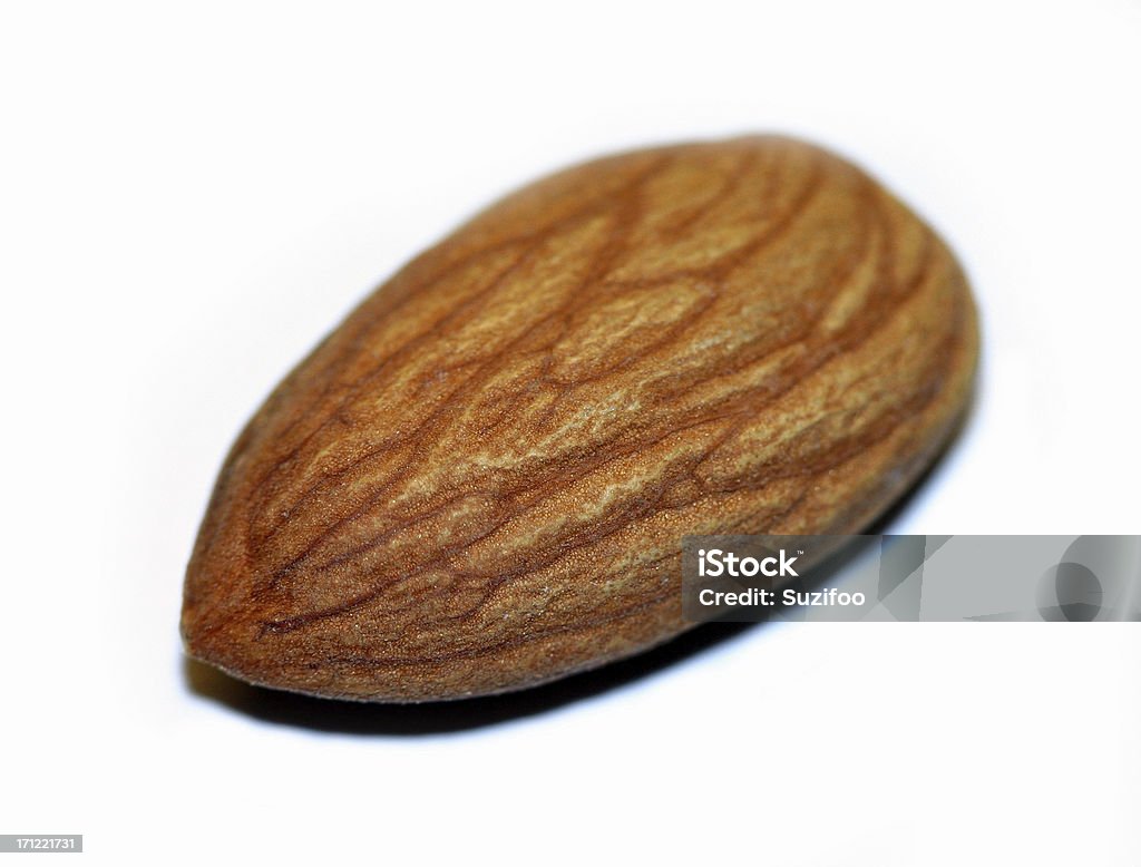 almond macro A closeup of an almond isolated on a white background.  Almond Stock Photo