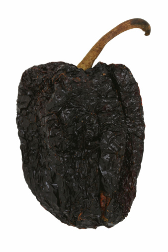 Ancho chiles are dried poblano peppers, commonly used in Mexican cuisine. Isolated on white.