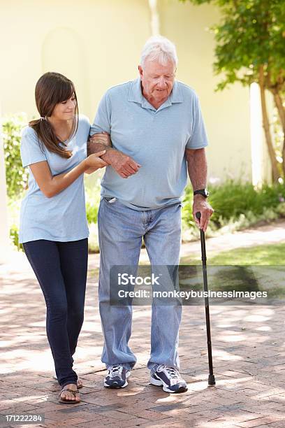 Nonno Aiutando Il Nipote Adolescente In Piedi - Fotografie stock e altre immagini di Terza età - Terza età, Uomini anziani, Assistenza