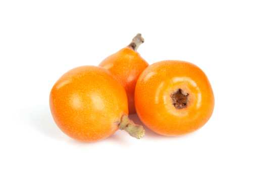 Loquats on white background