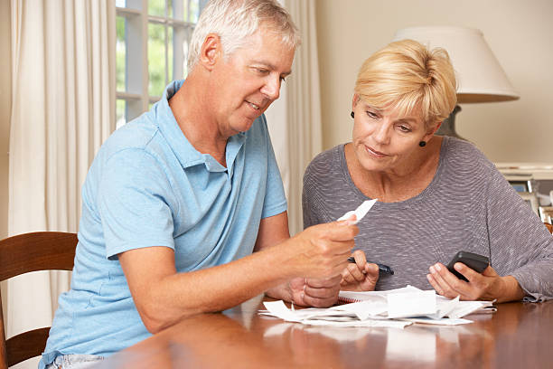 istock Mature Couple Checking Finances And Going Through Bills Together 171222773