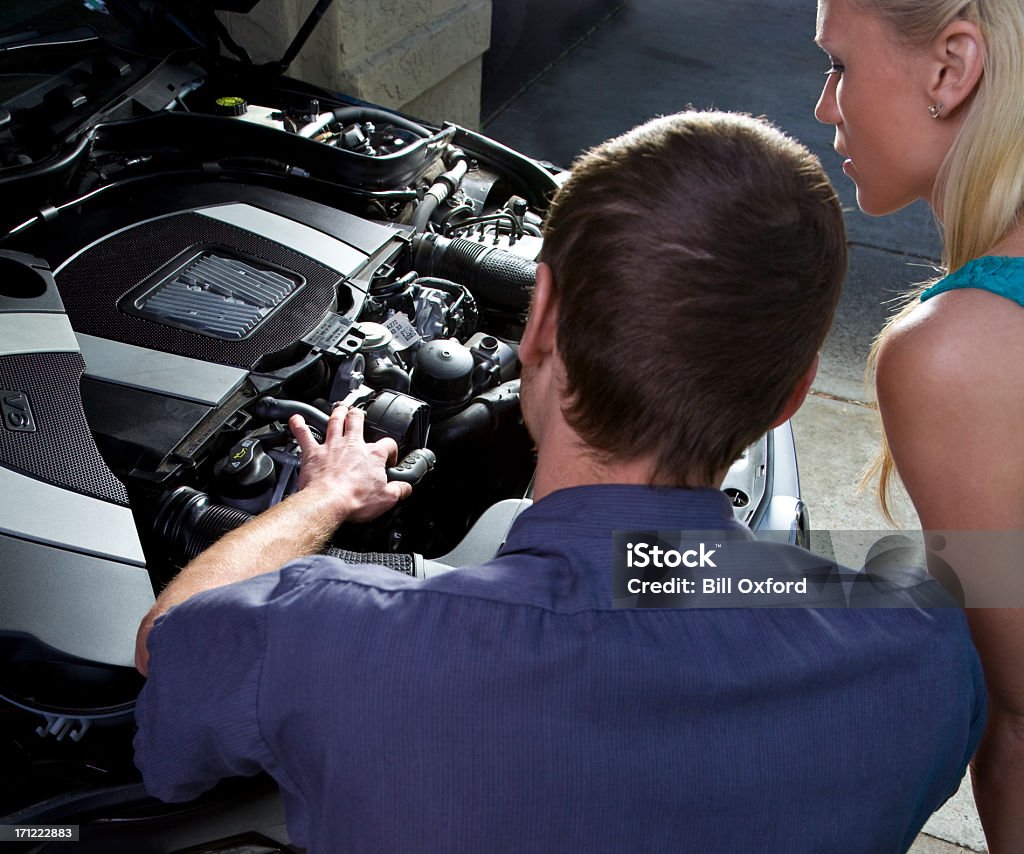 Auto Repair Auto mechanic with woman customer. Working on car. Adult Stock Photo