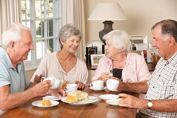 istock Group of senior couples enjoying afternoon tea at home 171222886