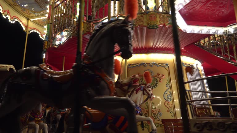 Beautiful illuminated carousel details during the round of the Christmas market. Vintage colorful carousel