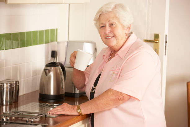 istock Retired Senior Woman In Kitchen Making Hot Drink 171223282