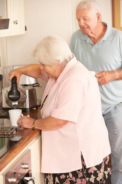 istock Retired Senior Couple In Kitchen Making Hot Drink Together 171223731