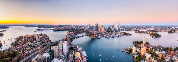 Wide aerial panorama of Sydney harbour aroudn major city architecture landmarks.