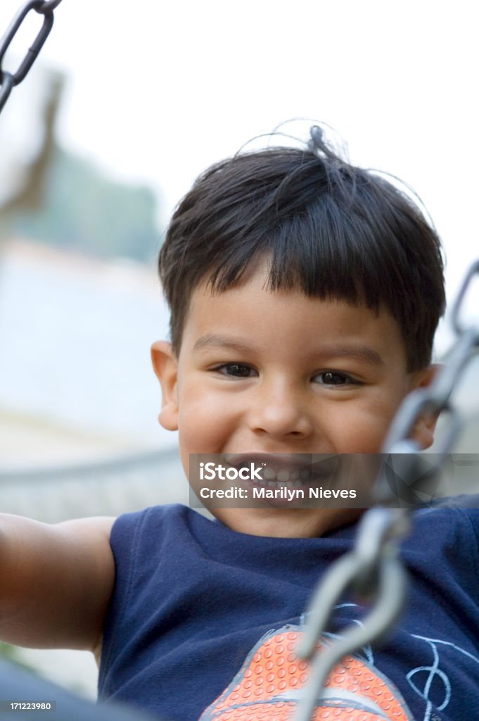 big smiles at the playground Toddler on the tire swing. 2-3 Years Stock Photo