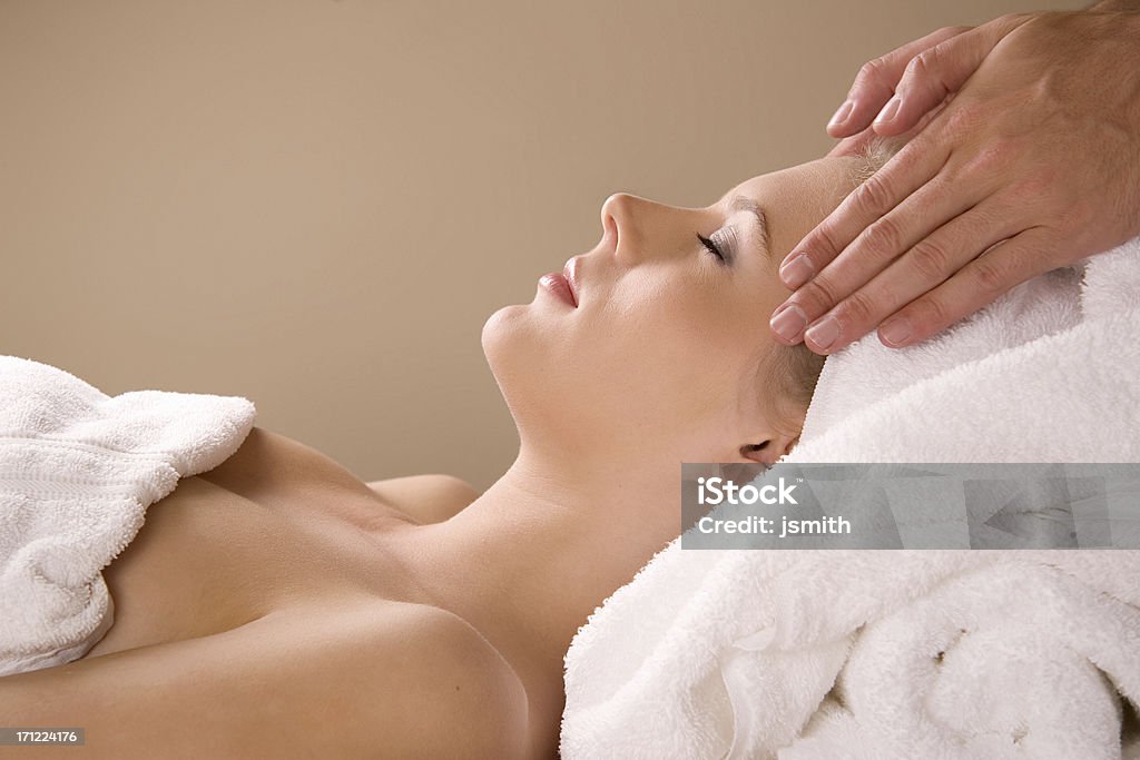 Spa Massage Woman receives a relaxing massage at a spa - with room for logo and copy in top left Massaging Stock Photo