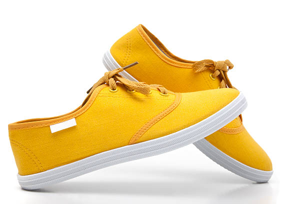 sapatos de lona - isolated on yellow imagens e fotografias de stock