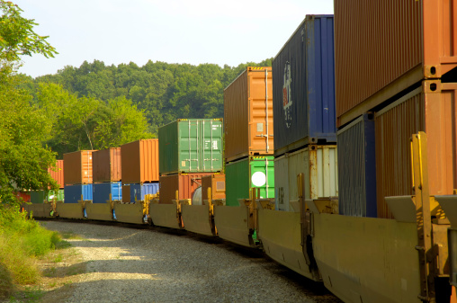 A long freight train hauls cargo across the country for consumer and industry consumption.