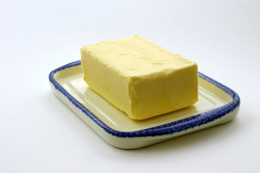 Block of butter on a butter dish.