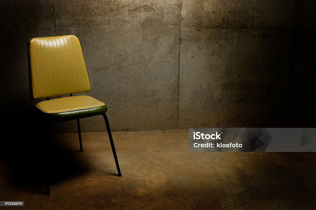 Interrogation Room Chair in dingy, cold interrogation room Asking Stock Photo