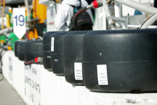 Race car tires sitting on pit lane wall