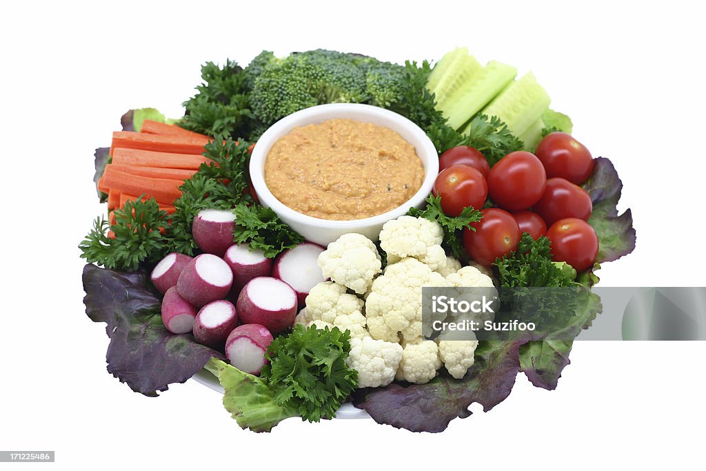 crudite platter with hummus A plate of fresh vegetables with a bowl of red pepper hummus for dipping. Isolated on white. Shot at an angle. Vegetable Stock Photo