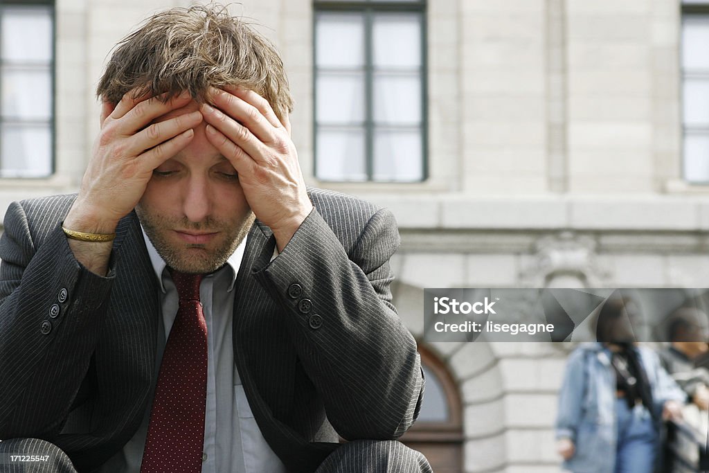 Overwork (close-up) Businessman's close-up holding head. Adult Stock Photo