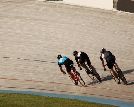 Three racers fight for first place at the velodrome.