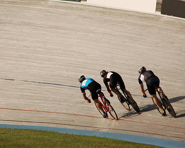 Fighting For First Three racers fight for first place at the velodrome. velodrome stock pictures, royalty-free photos & images