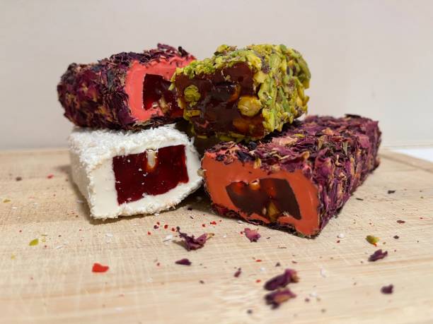 istock Turkish delight with pomegranate and rose, Turkish delight on the board. 1712268472