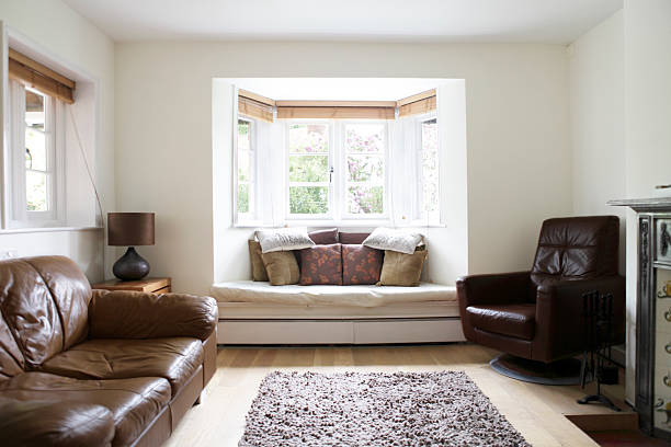 Living Room Interior A bright and airy living room with a bay window seat and wooden floor. bay window stock pictures, royalty-free photos & images