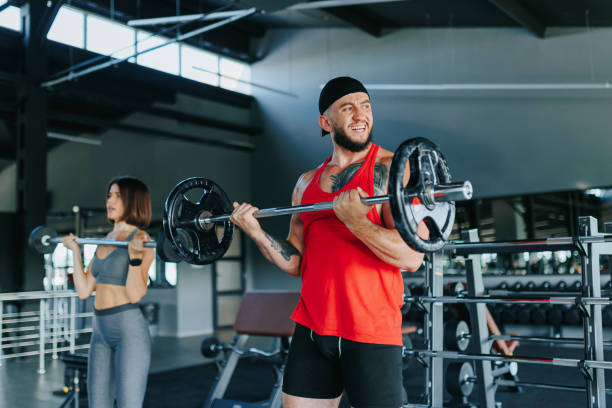 istock Indoor Gym Session Two Dedicated Individuals Lift Weights 1712314710