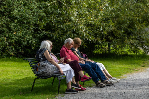 Vilnius, Lithuania - August 31, 2017: Public Park in Lithuania, Vilnius. Old Woman Sitting on The Bench