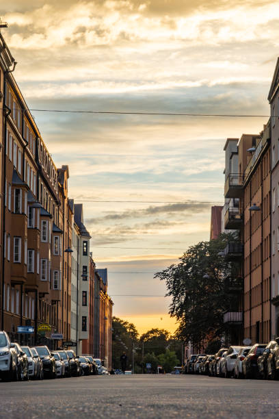 Stockholm, Sweden Sept 13, 2023 Cars parked and the sunset seen from the Heleneborgsgatan street in the Hornstull district on Sodermalm.
