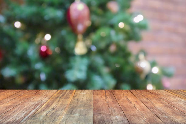 istock Empty wood table top with blur Christmas tree with bokeh light background 1712328166