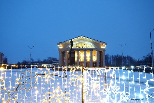 Petrozavodsk, Karelia, January 10, 2023. Russian Drama Theatre. Musical theater of the Republic of Karelia. New Year's decoration of the theater facade. Snowdrifts. Evening lighting. New Year's street