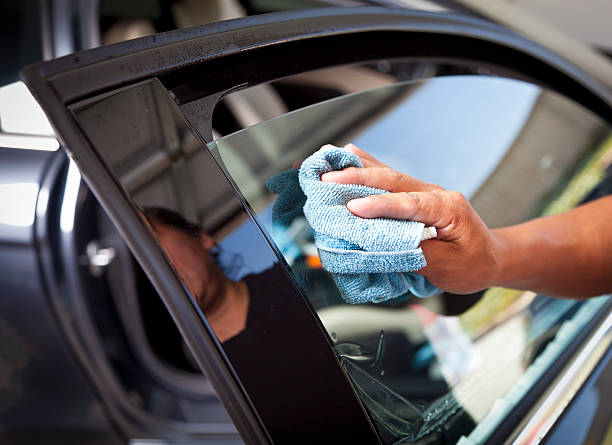 Car Window Tinting Man installing window tinting on car. toned image stock pictures, royalty-free photos & images