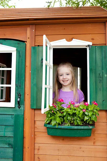 Young girl in a playhouse.