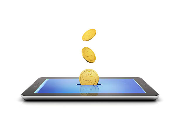 Golden coins flying out of a slit in a tablet stock photo