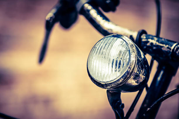 Vintage Bicycle Light, Italian Street Selective focus on an old bicycle light. Shallow depth of field. bicycle light photos stock pictures, royalty-free photos & images