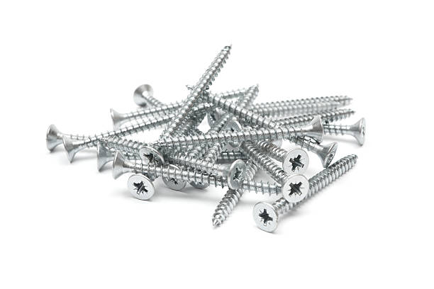 Heap of zinc plated screws isolated on a white background.