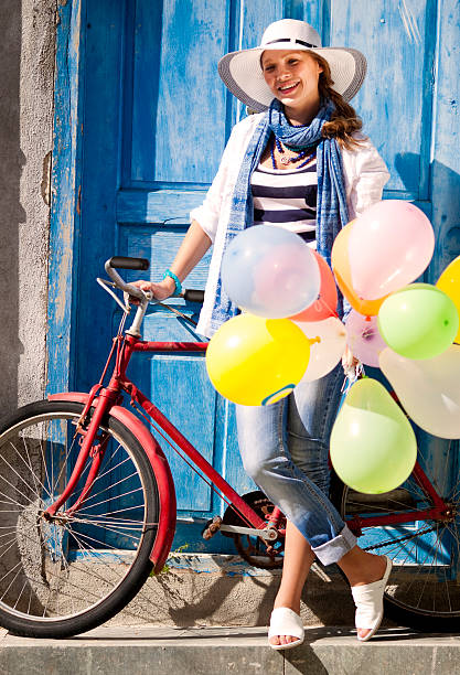 istock Woman with balloons standing her classic bicycle 171237761