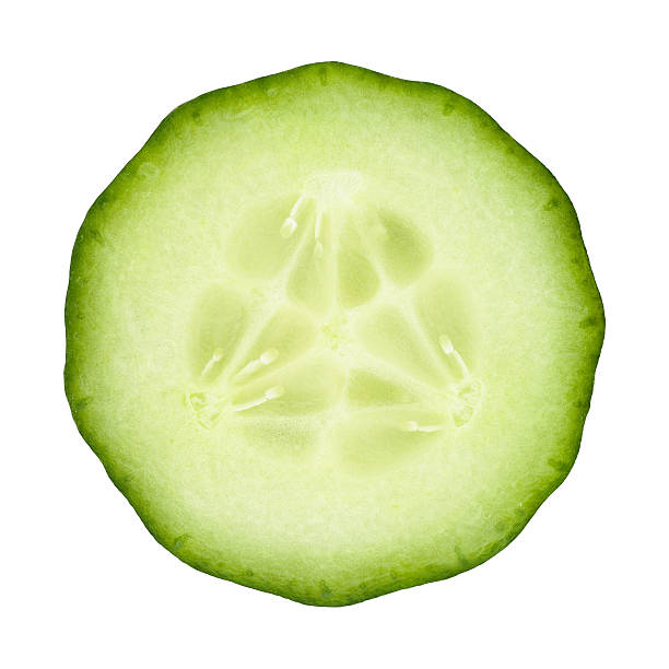 Cucumber portion on white Cucumber circle portion on white background. Clipping path included. cucumber slice stock pictures, royalty-free photos & images