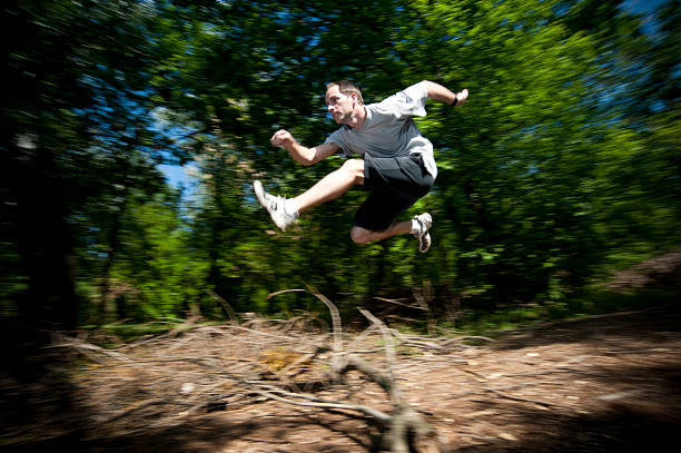 istock Panning shot of a man jumping over obstacle 171239048
