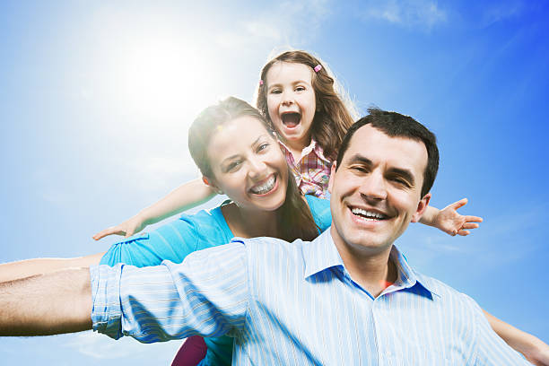 istock Cheerful family with raised hands against the sky. 171239202