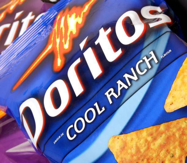 Doritos Cool Ranch "Edmonton, Canada - April 28, 2012: A close-up picture of a bag of Doritos Cool Ranch tortilla chips. Doritos have been produced since 1964 by food company Frito-Lay, a division of PepsiCo, Inc." Doritos stock pictures, royalty-free photos & images