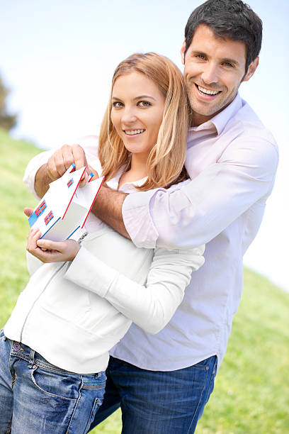 happy couple posing house miniature saving box "happy couple inserting 2 euroA's in a house-model saving box for hypothical and future family concepts,selective focus, saving box is selfmade by me" hypothecary stock pictures, royalty-free photos & images