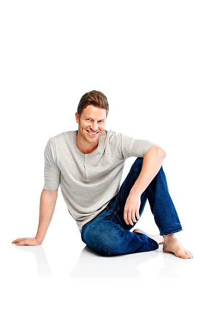 istock Smiling young man sitting on floor 171239763