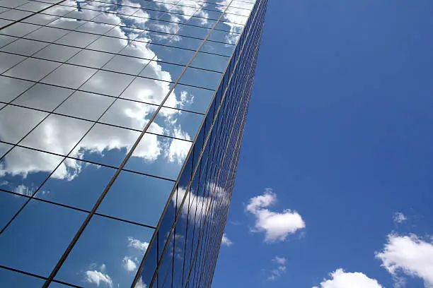Photo of Skyscraper reflecting clouds in the sky