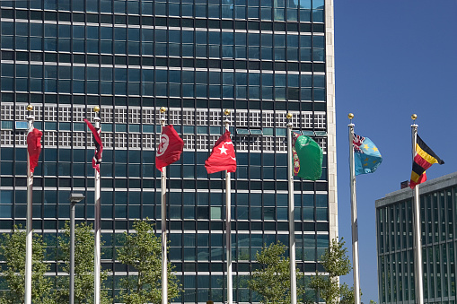 New York, NY, USA - June 7, 2022: Country flags flying in front of the United Nations Secretariat building.