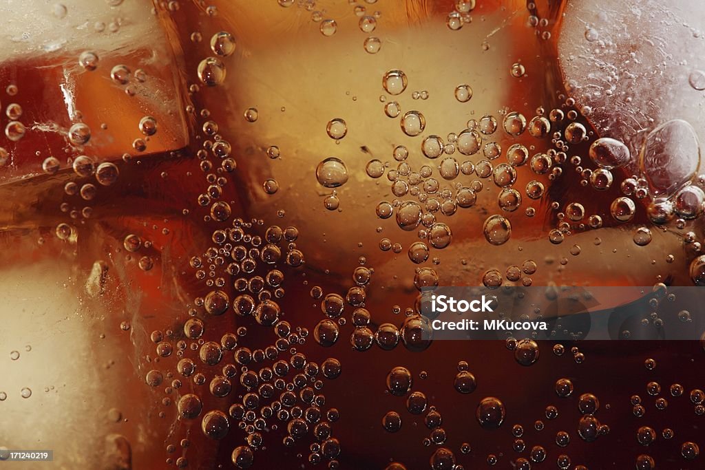 Cola close-up Macro shot of glass with cola drink and ice cubes. Cola Stock Photo